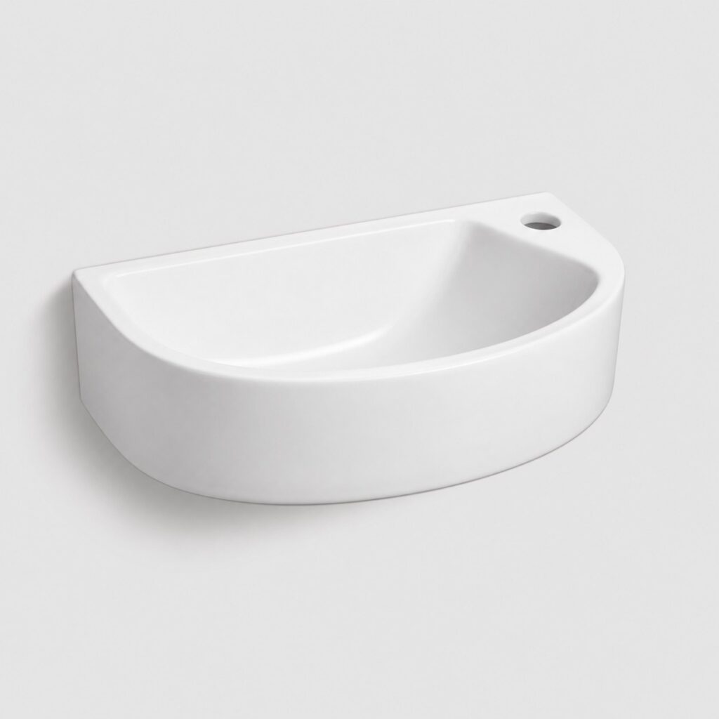 Lavabo compact mural blanc, fond clair, vue de trois‑quarts.